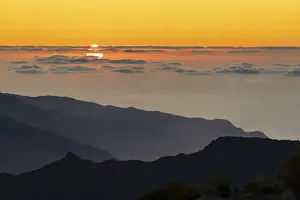 Solar Flare Prints: Burning sky at sunset over the Atlantic Ocean and silhouettes of mountains from Pico
