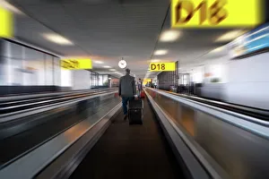 Images Dated 15th July 2009: Businessman with luggage on travelator at Schiphol airport, Amsterdam, Netherlands