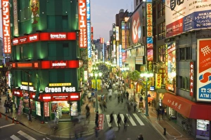 Bustling Prints: Busy streets and neon signs in the evening at Shinjuku station