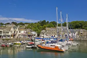 Yachts Prints: Busy tourist shops, small boats and yachts at high tide in Padstow harbour