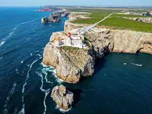 Beacon Prints: Cabo de Sao Vicente lighthouse stands on a cliff above the Atlantic Ocean in Sagres