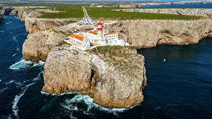 Bright Prints: Cabo de Sao Vicente lighthouse stands on cliff above the ocean in Sagres