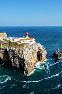 Bright Prints: Cabo de Sao Vicente lighthouse stands on cliffs overlooking ocean waters in Sagres Algarve Portugal