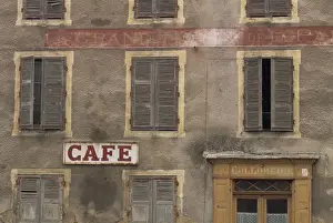 Auvergne Prints: Cafe sign on the outside of an old hotel building with wooden shutters at Mauriac in the Auvergne