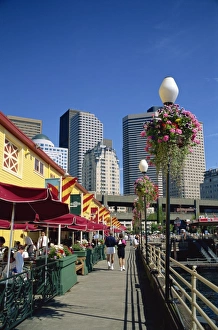 Cafes on Pier 56 on the waterfront with tower blocks
