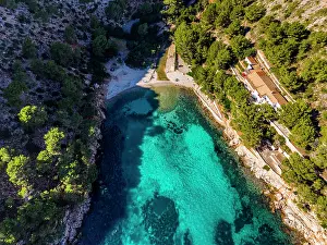 Swimming Prints: Cala Murta beach on Formentor peninsula shows clear water and greenery near the shore in Mallorca Spain