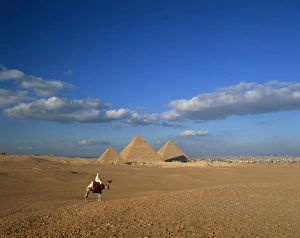 Images Dated 5th February 2008: Camel rider at Giza Pyramids, Giza, UNESCO World Heritage Site, Cairo, Egypt