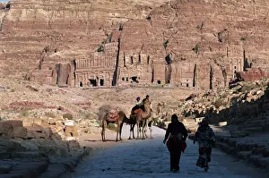 Camels in front of rock cut tombs at Nabatean archaeological site