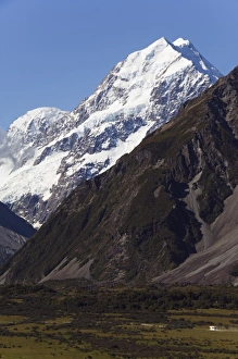 A camper van is dwarfed by Aoraki (Mount Cook)