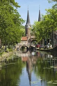 Delft Prints: Canal scene with bridge, 16th century East Port Gate Towers, Delft, Holland, Europe
