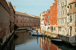 Waterways Prints: Canal view with boats and colorful buildings in Venice during a clear day