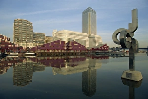 Docklands Prints: Canary Wharf and modern art sculpture reflected in pond, Docklands, London