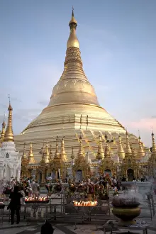 Pilgrimage Site Prints: Candles placed by devotees at sunset in front of the golden Shwesagon Pagoda, a 2500