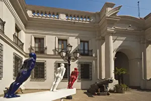 Cannon and modern art on display in an inner courtyard of the Palacio de La Moneda