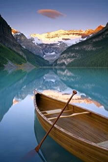 Images Dated 21st August 2011: Canoe on Lake Louise at Sunrise, Lake Louise, Banff National Park, Alberta, Canada