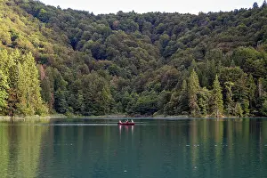 National Prints: Canoeing on the calm waters of Plitvice Lakes National Park in Croatia during late afternoon