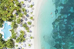 Swimming Pools Prints: Canoes floating in the crystal sea overlooking a tropical sand beach with swimming pool