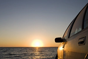 Motorcar Prints: Car on the beach at sunset