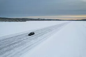 What's New: Car on icy road on a frozen lake from above, aerial view, Lapland, Sweden, Scandinavia, Europe