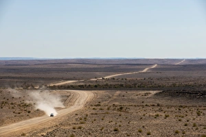 Dust Gallery: A car leaves a cloud of dust as it apporachs along the long dusty road from the Fish River Canyon