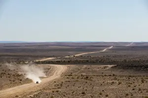 Dust Prints: A car leaves a cloud of dust as it apporachs along the long dusty road from the Fish River Canyon