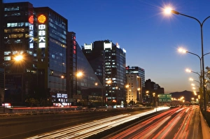 Images Dated 31st October 2007: Car light trails and modern architecture on a city ring road, Beijing, China, Asia