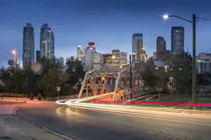 Canadian Culture Prints: Car trail lights through Macdonal Avenue bridge and Downtown skyline at dusk, Calgary