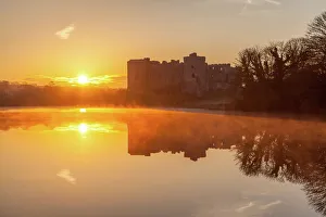 Glowing Prints: Carew Castle sunrise, Pembrokeshire, Wales, United Kingdom, Europe