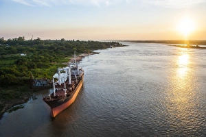 Paraguay Prints: Cargo boat at sunset on the Asuncion River, Paraguay, South America
