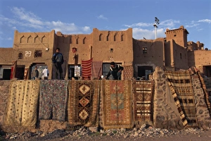 Ouarzazate Prints: Carpets and rugs displayed on walls outdoors for sale