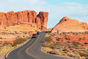 Vehicles Prints: Two cars drive along the scenic road in Valley of Fire State Park on a sunny summer day