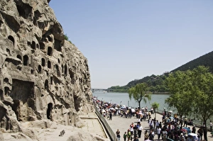 Carved Buddha images at Longmen Caves, Dragon Gate Grottoes, on the Yi He River dating from the 6th to 8th Centuries, UNESCO World Heritage Site, Henan Province