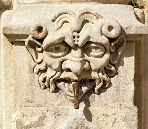 Cuenca Prints: Carved stone face with snake spout emerging from mouth