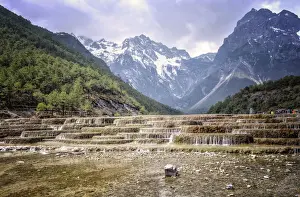 Flowing Prints: Cascading falls at Baishuihe with Jade Dragon Snow Mountain backdrop