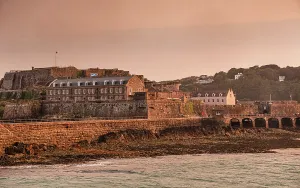 Channel Prints: Castle Cornet shines in sunset light above the harbor at St. Peter Port in Guernsey