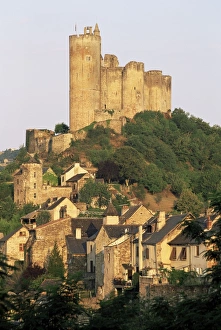 Aveyron Prints: The castle towering above village houses, in early morning light, Najac