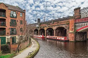 British Isles Prints: Castlefield neighbourhood canals with moored cruise narrowboats on the waterfront