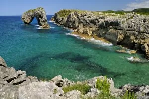 Castro de Gaviotas (Gulls fort) karst limestone rock archway, and La Canalina bay, near Llanes, Asturias, Spain, Europe