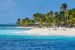 Windward Islands Prints: Catamarans on a beautiful palm fringed white sand beach on Palm Island