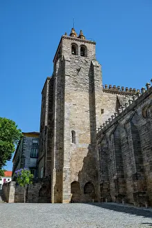 Spot Prints: Cathedral of Vora stands tall under bright blue sky in Evora, Portugal