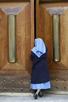 Catholic nun opening a door, Rome, Lazio, Italy, Europe