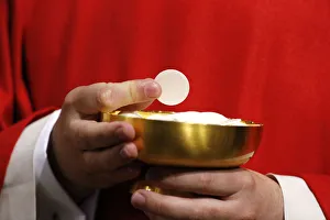 Bowl Prints: Catholic priest giving Holy Communion, Paris, France, Europe