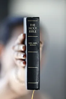 Obscured Face Prints: Catholic woman with the Holy Bible in hands, Vietnam, Indochina, Southeast Asia, Asia