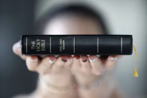 Obscured Face Prints: Catholic woman with the Holy Bible in hands, Vietnam, Indochina, Southeast Asia, Asia
