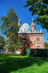 Towers Prints: Central mosque of Vladikavkaz stands with its blue dome in bright sunlight surrounded by trees