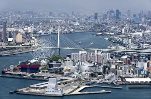 Central Osaka City behind the Tempozan Bridge which crosses over the Aji River at Osaka Bay