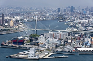Central Osaka City behind the Tempozan Bridge which crosses over the Aji River at Osaka Bay Central Osaka City behind the Tempozan Bridge which crosses over the Aji River at Osaka Bay