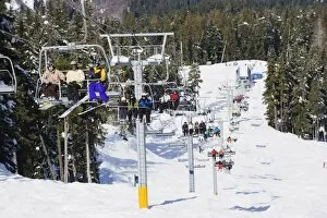 Images Dated 31st March 2009: Chairlift with skiers, Whistler mountain resort, venue of the 2010 Winter Olympic Games