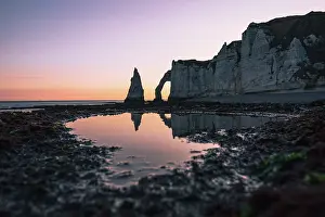 Wanderlust Prints: Chalk cliffs and natural arch reflect in tidal pool at sunrise on the Normandy coast of France