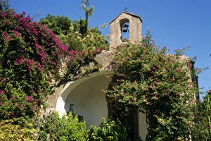 Chapel and bell tower covered in lantana and bougainvillea